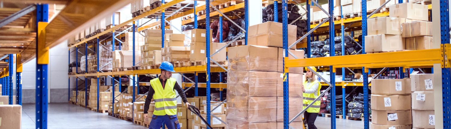 Warehouse workers pulling a pallet truck.