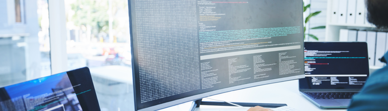 Computer, programmer or technician man for coding, software script or cyber security in office. Behind IT engineer person with technology for programming, future ui and data analytics or innovation